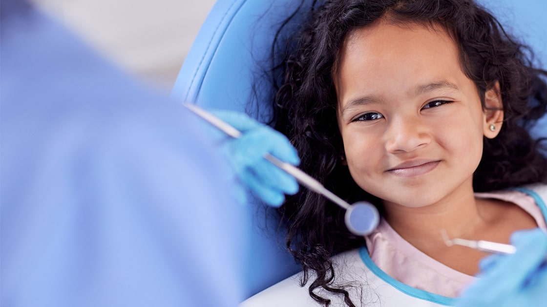 Child with dark hair at dentist