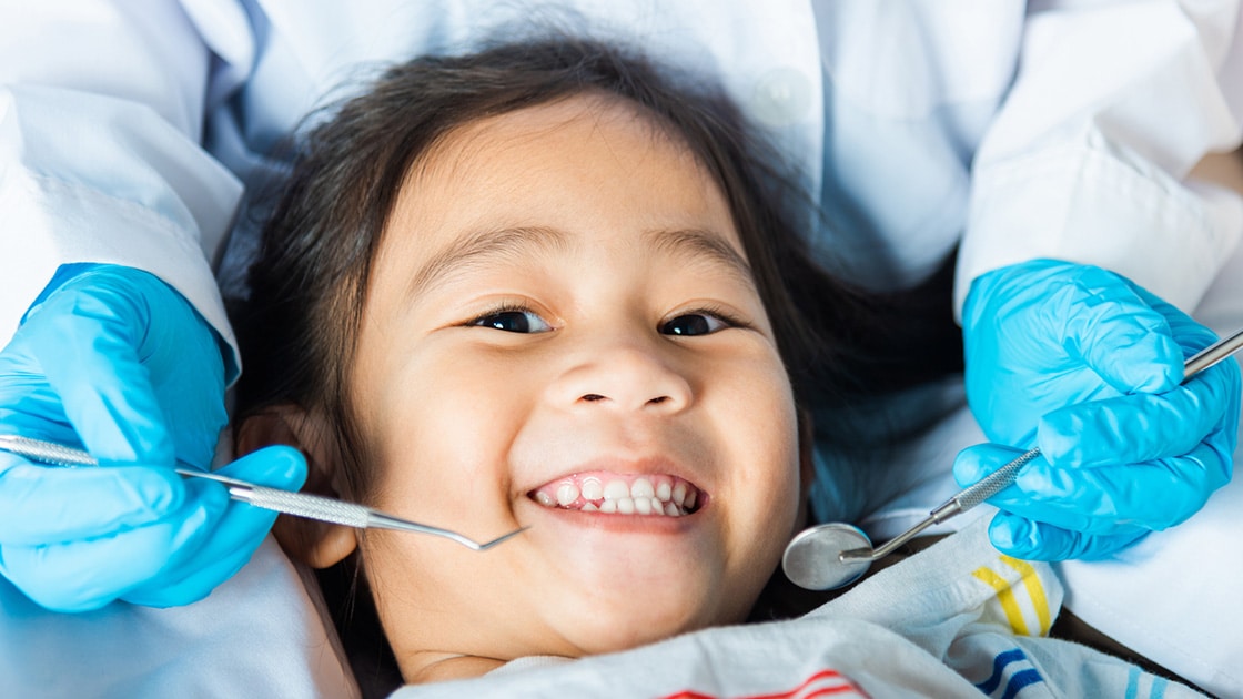 Happy child in dentist chair 
